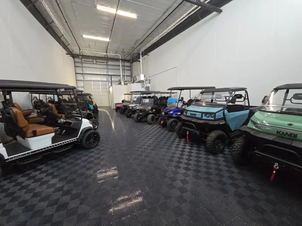 Lifted golf cart and UTV at our showroom